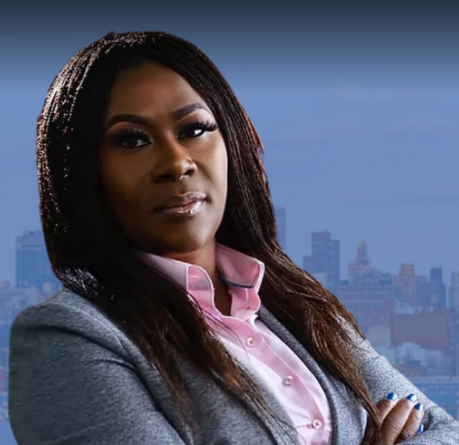 Portrait of Attorney Ifeoma Odunlami in a grey suit and pink blouse.